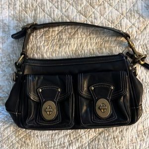 Black leather coach bag with metal detailing